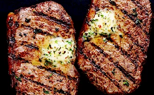 Photograph of Valentine's Day steaks chargrilled with herb butter