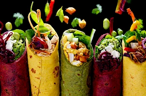 Photograph of Wraps with ingredients falling into them.