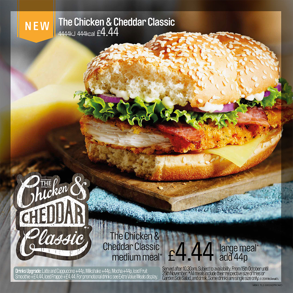 Advert for Chicken and Cheddar Classic Burger. Photograph of burger on a board.
