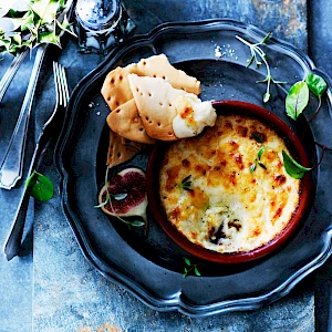 Photograph of Waitrose Cheese bake in terracotta dish with crackers