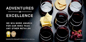 Advert for Adventures in excellence campaign. Photograph of glasses of red wine with chunks of cheese, grapes and crackers.