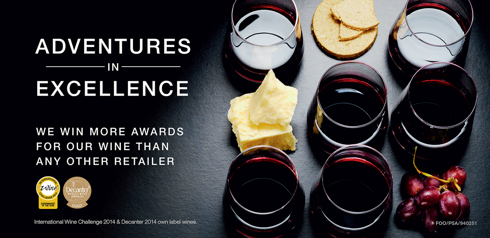 Advert for Adventures in excellence campaign. Photograph of glasses of red wine with chunks of cheese, grapes and crackers.