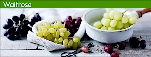 Photograph of bunches of grapes in a napkin and a colander