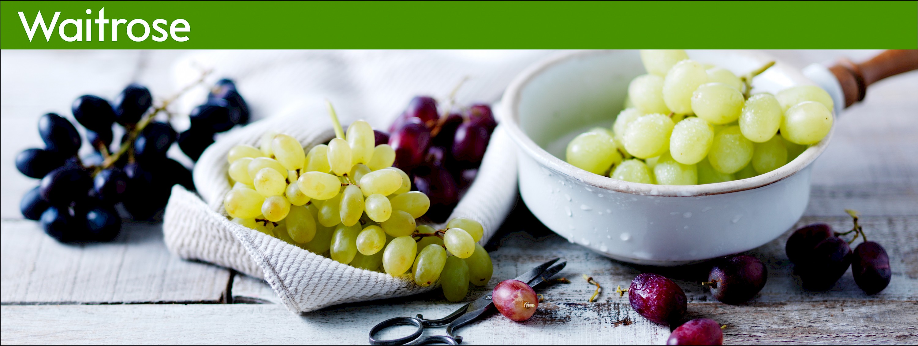 Photograph of bunches of grapes in a napkin and a colander
