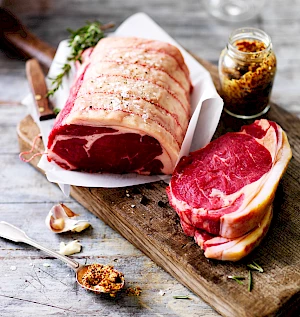 Waitrose Service Counter Meat. Photograph of beef joint on chopping board with jar of mustard.