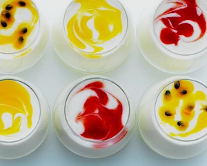 Photograph of Marks and Spencer glasses of fruit shot with yogurt and passion fruit topping