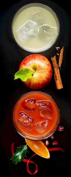 Fresh Christmas Apple Juices with whole apple and cinnamon garnish