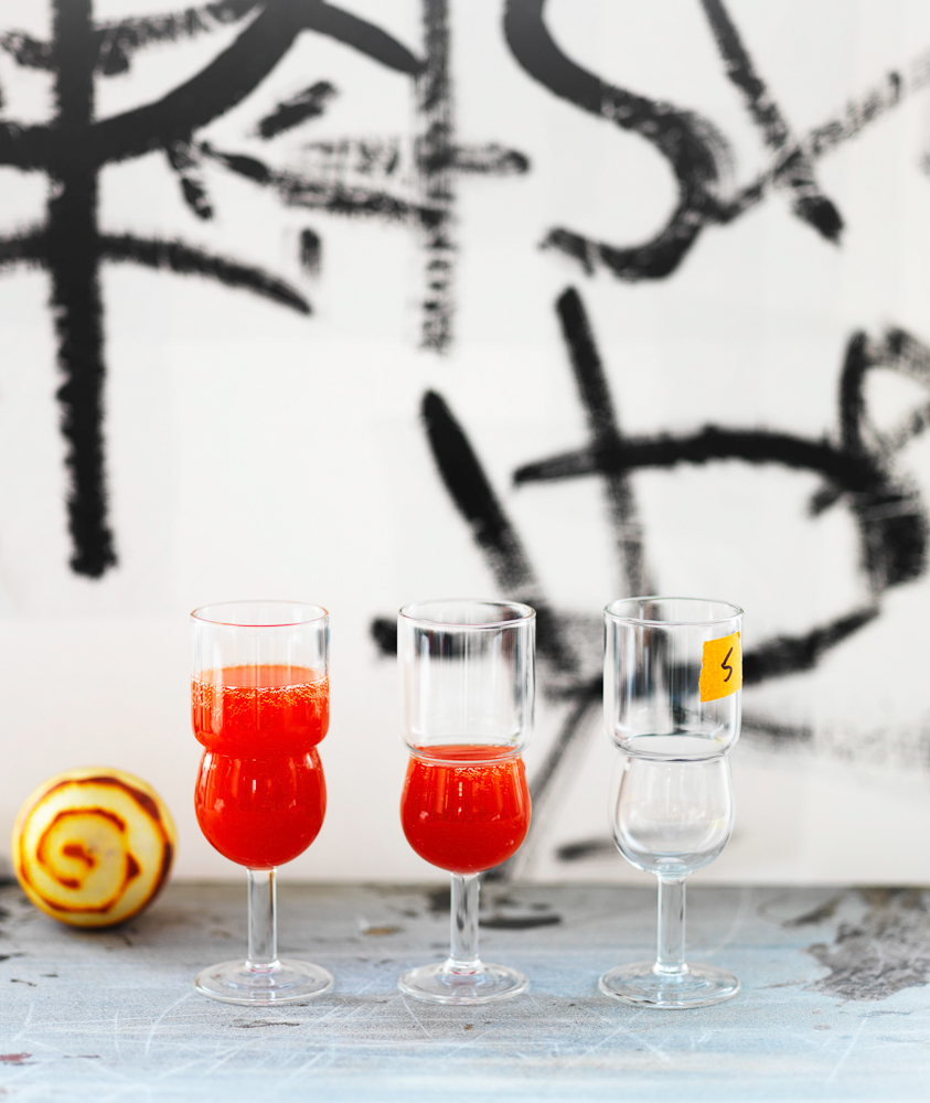 Photograph of a Red Pepper Bellini with a peeled orange and graffiti