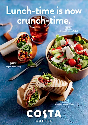 Photograph of  two wraps, salad and iced coffee