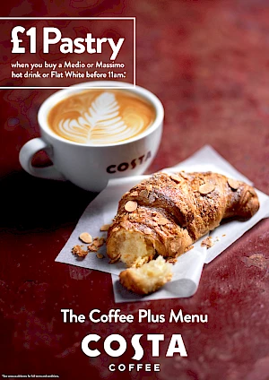 Photograph of a flat white with an almond croissant