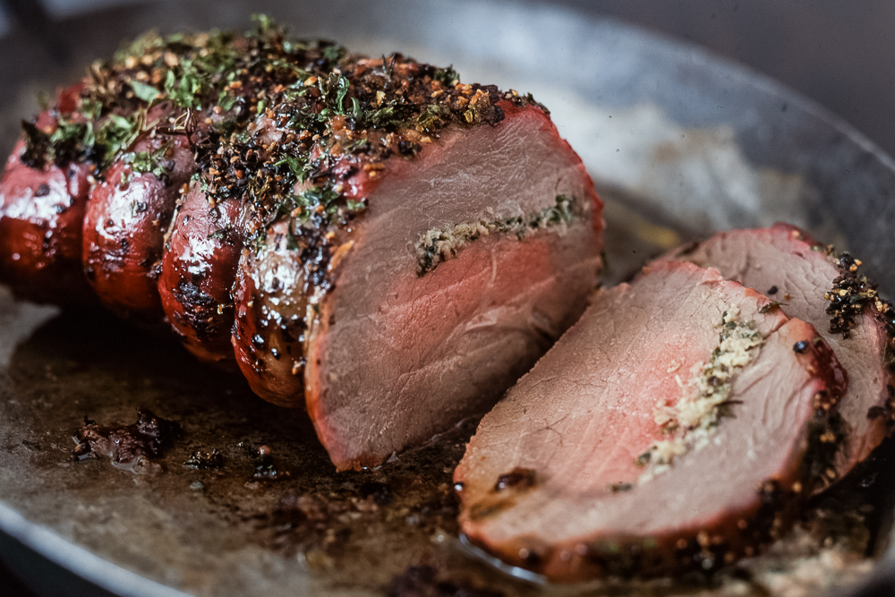 Roasting beef stuffed with herb butter_
