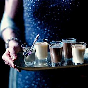 Hands holding Christmas Party Jellies and Mousse on Tray