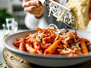 Penne pasta with grated cheese